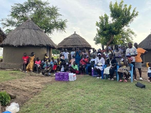 Community gathering near thatched homes
